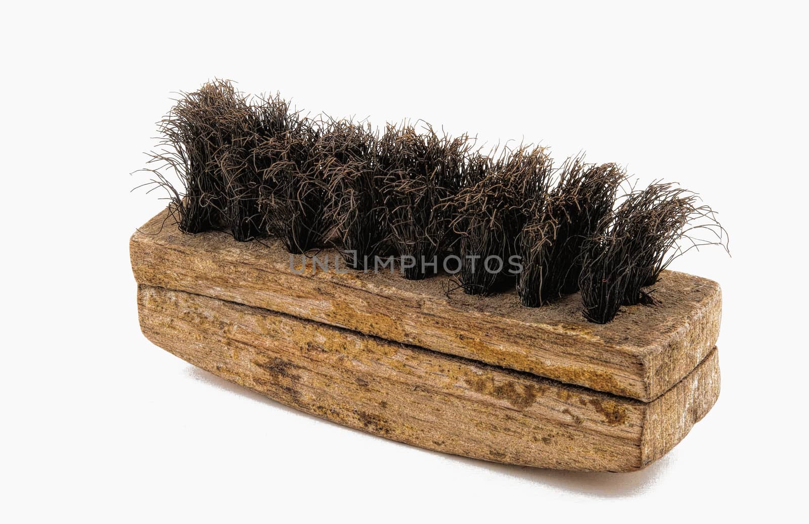 Bronze brush with a wooden handle, for cleaning suede photographed against a white background