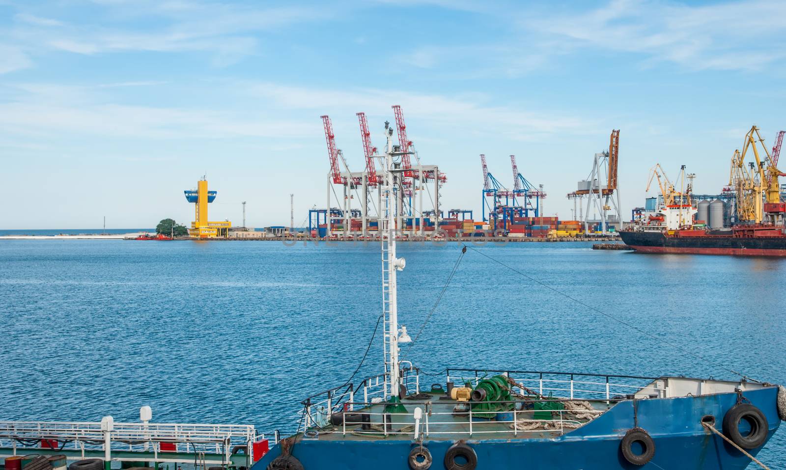 Port cargo crane and container over blue sky background