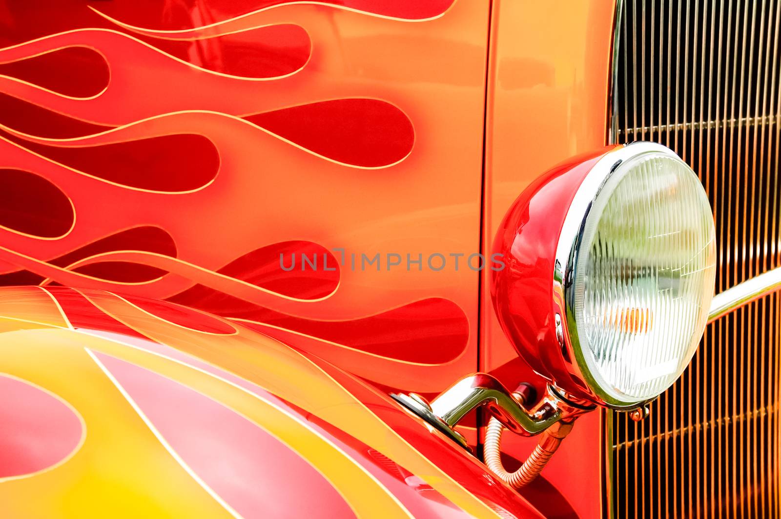 colorful flaming paintwork and headlamp on a custom hotrod