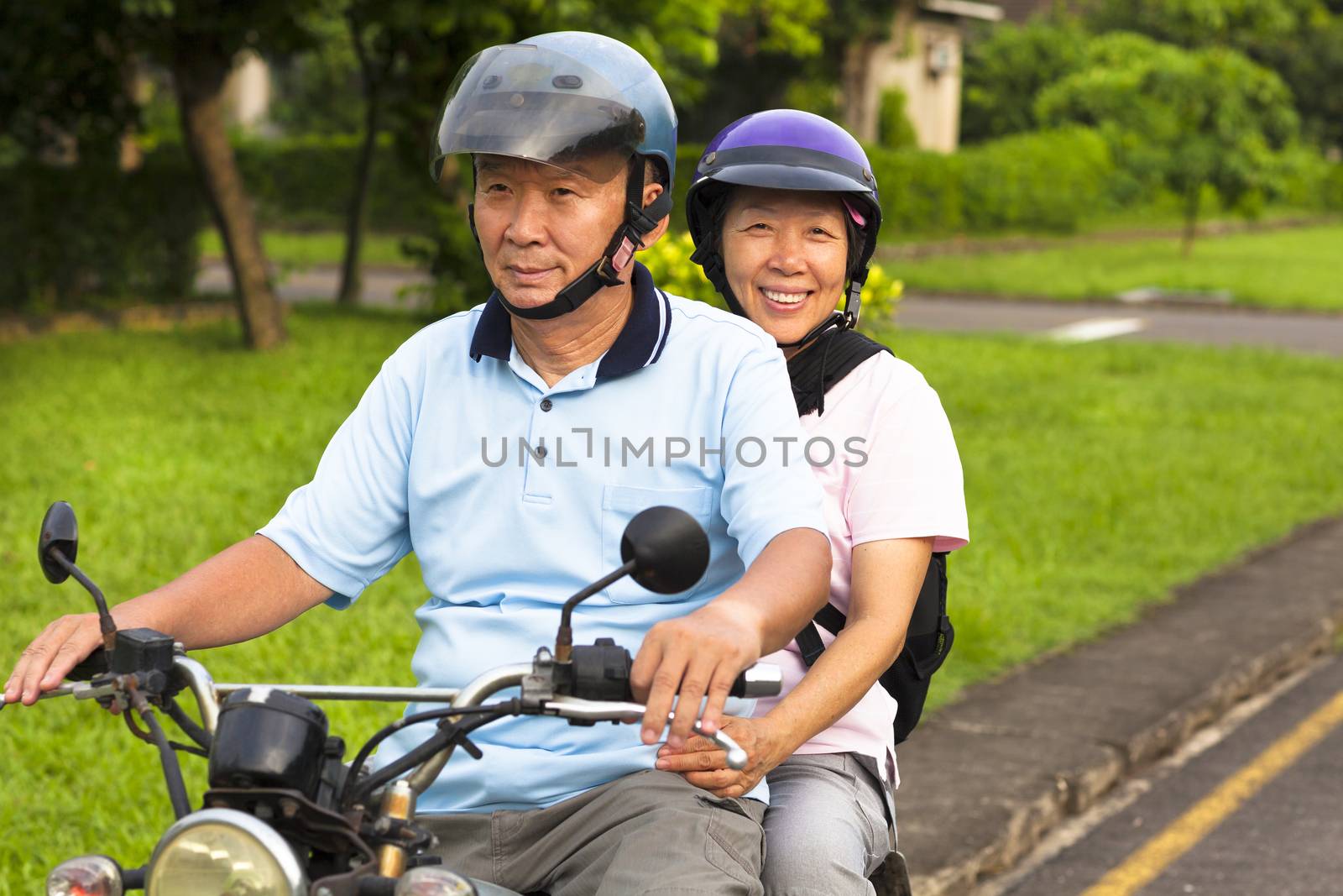 senior couple drive motorcycle to travel by tomwang