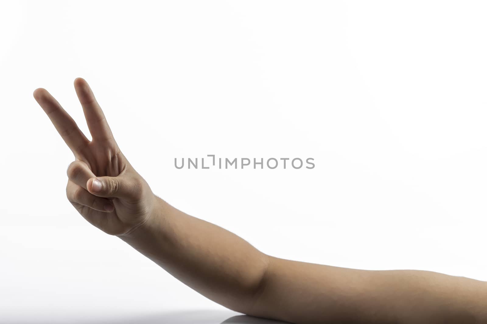 Young hands makes a gesture: victory sign with two fingers