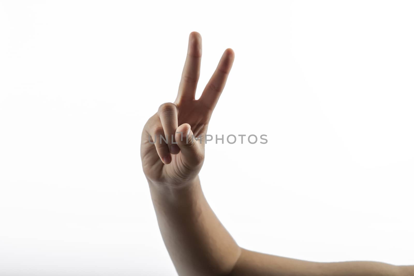 Young hands makes a gesture: victory sign with two fingers