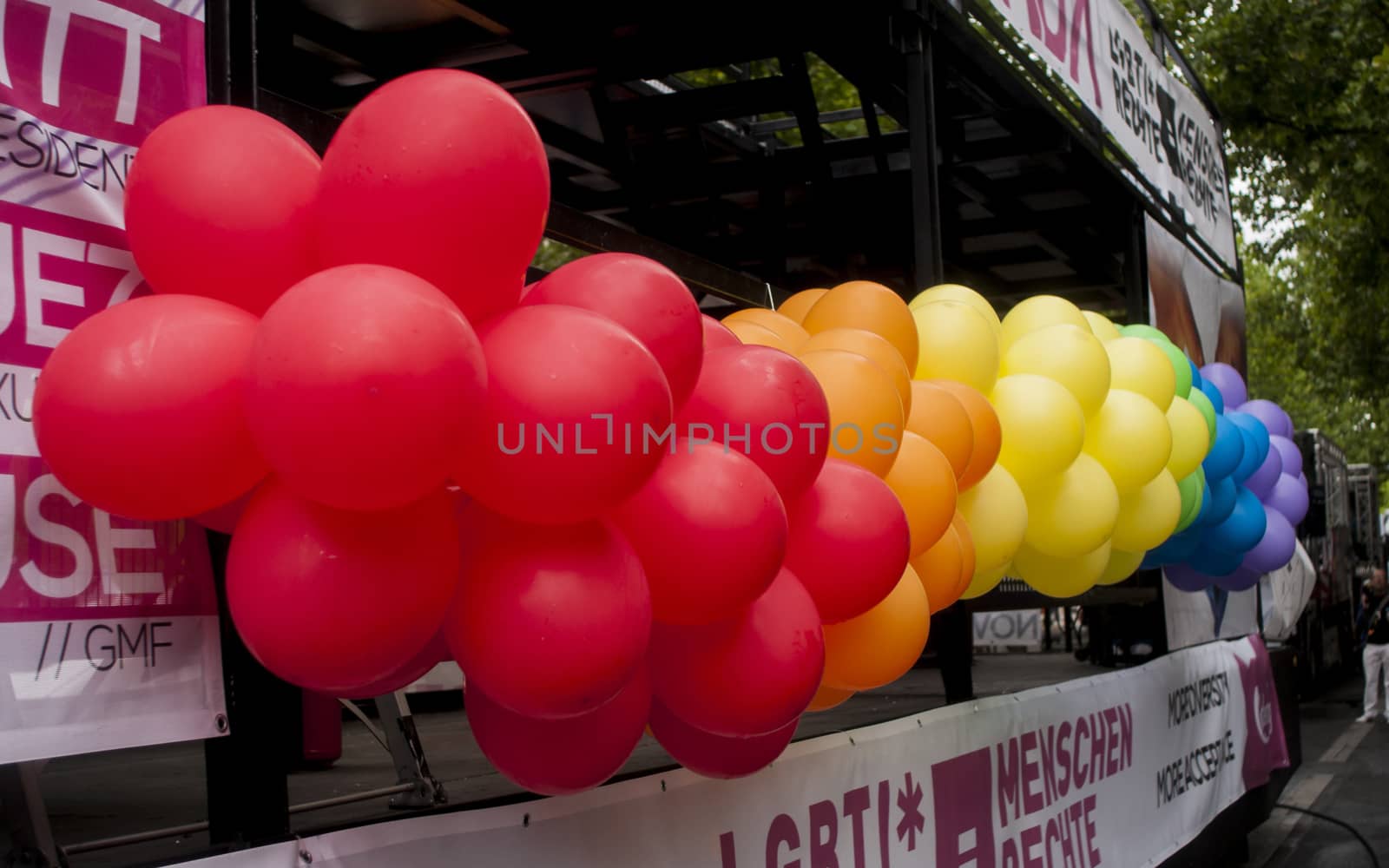 BERLIN, GERMANY - JUNE 21, 2014: Christopher Street Day.Crowd of people Participate in the parade celebrates gays, lesbians, bisexuals and transgenders.Prominent in the image a multicolour balloons.