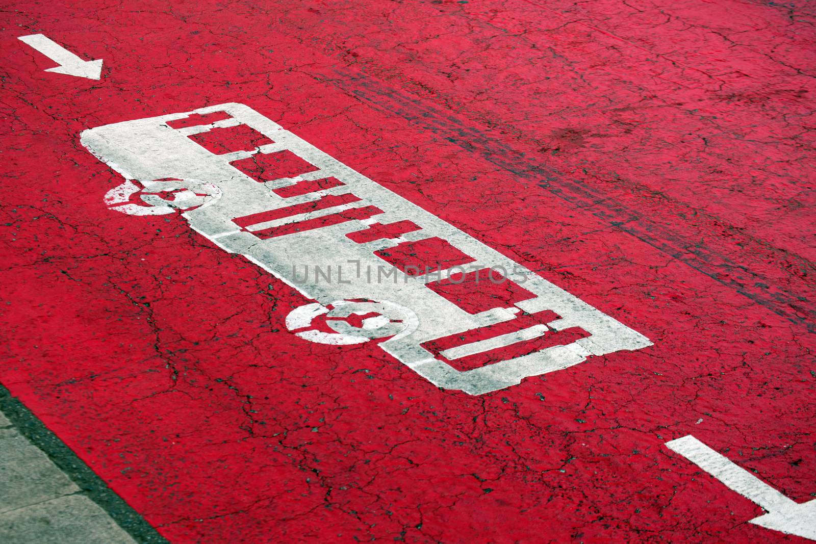 Red lane, access for buses only, painted on the asphalt in Barcelona, Spain
