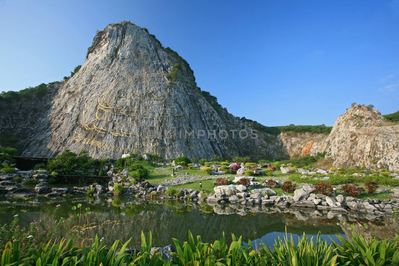 Carved buddha image on the cliff at Khao Chee Jan, Pattaya, Thailand