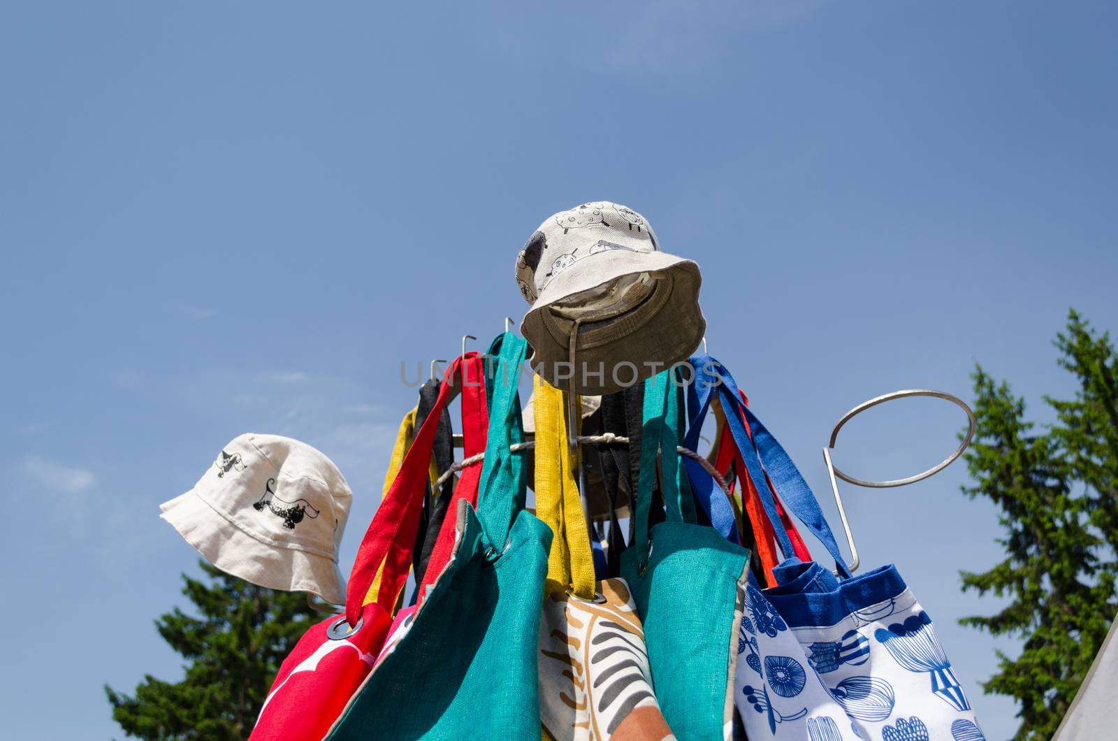 linen cap bag on fair stand on blue sky background by sauletas