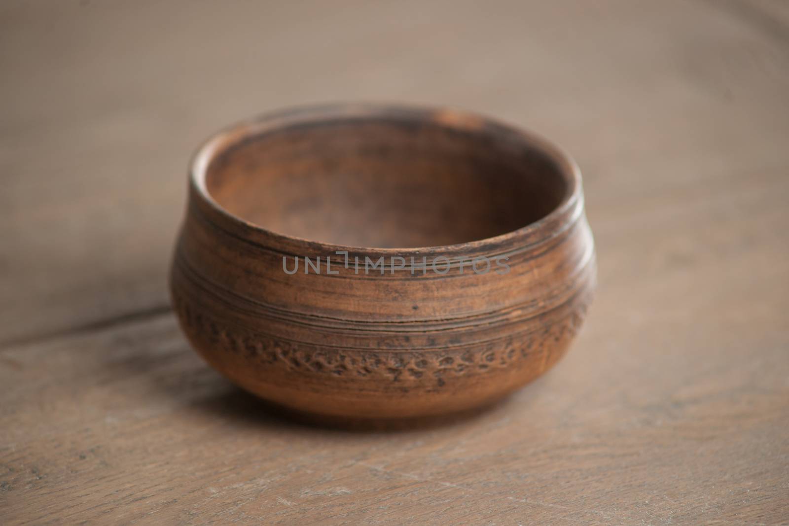 Traditional handcrafted dish of brown color on the table