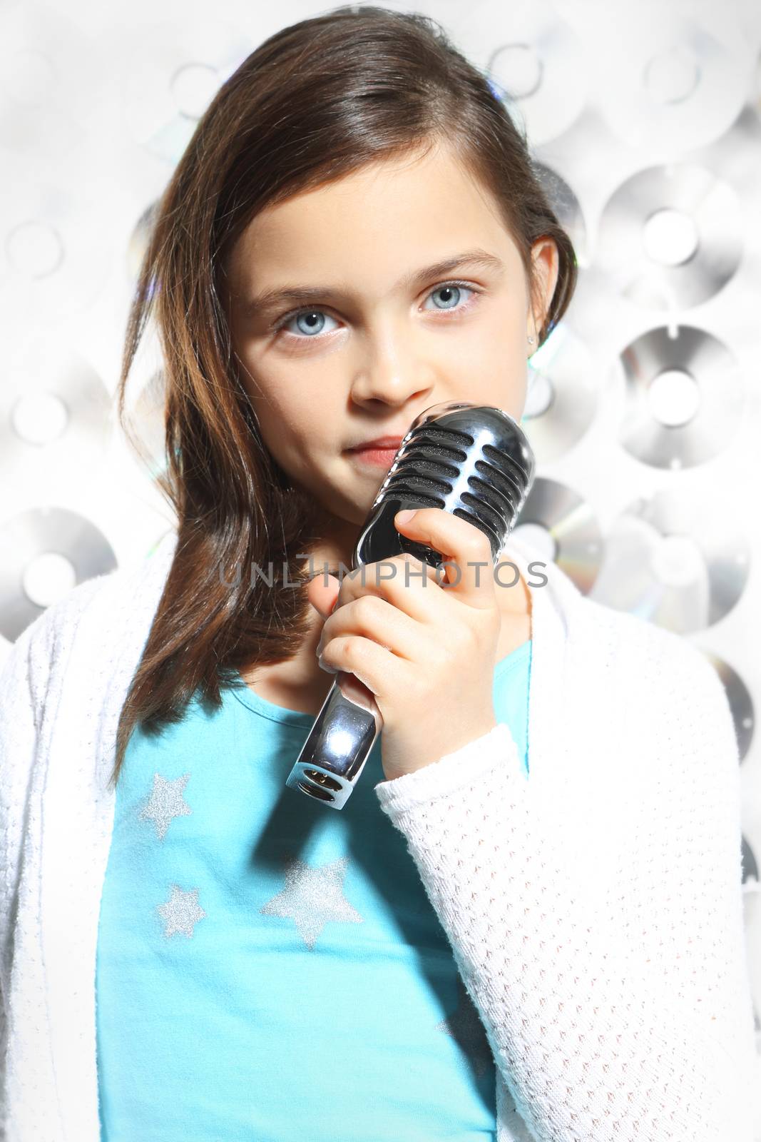 Child, teen, girl, singing into a microphone, a small singer