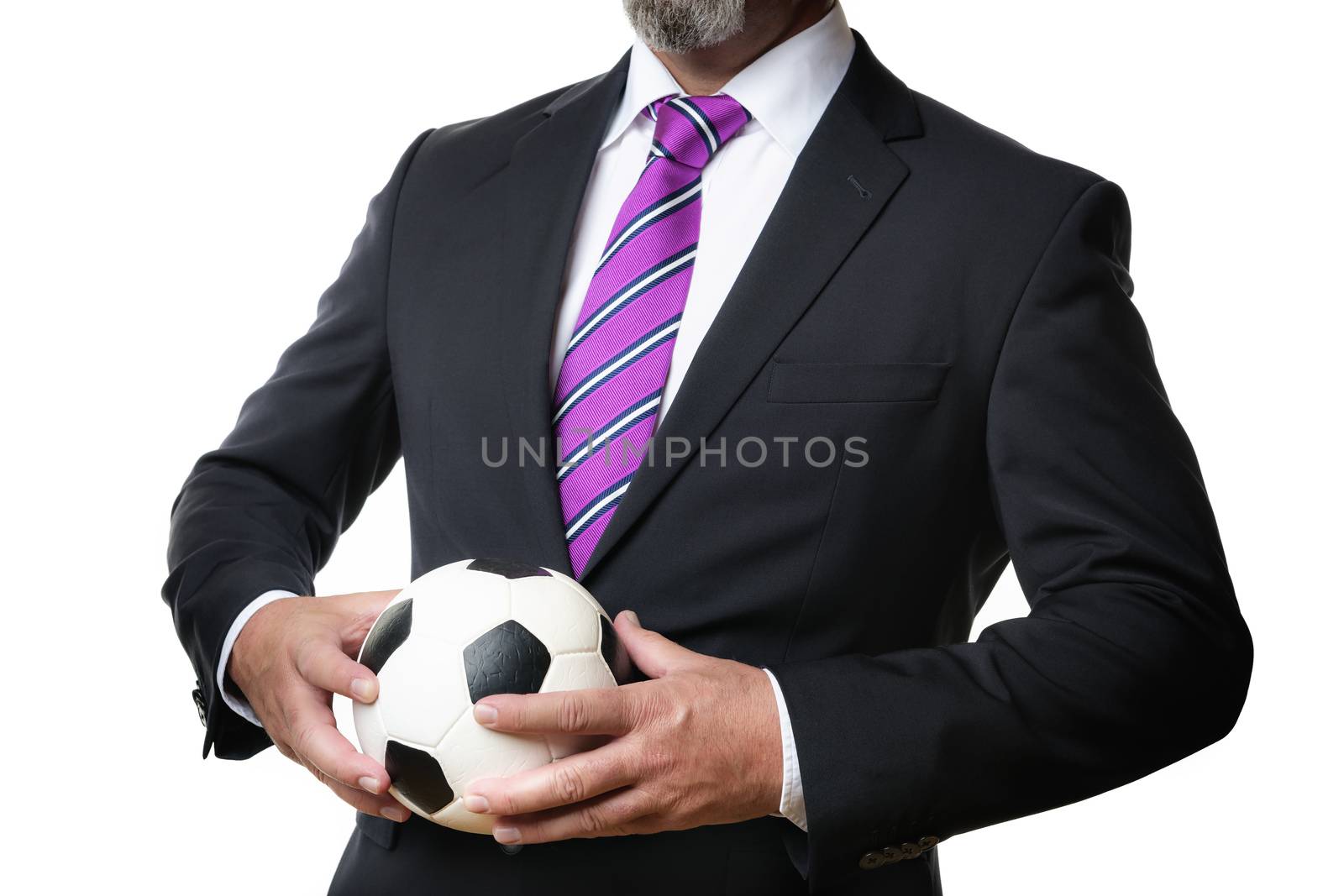 Business man in dark suit and tie holds a soccer ball