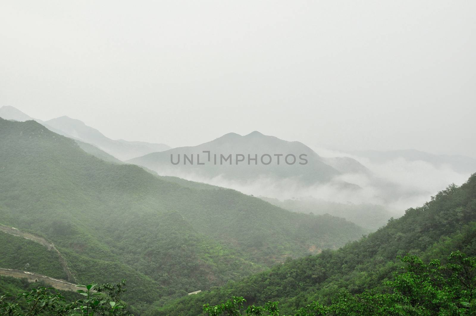 Great Wall fog over mountains in Beijing, China.