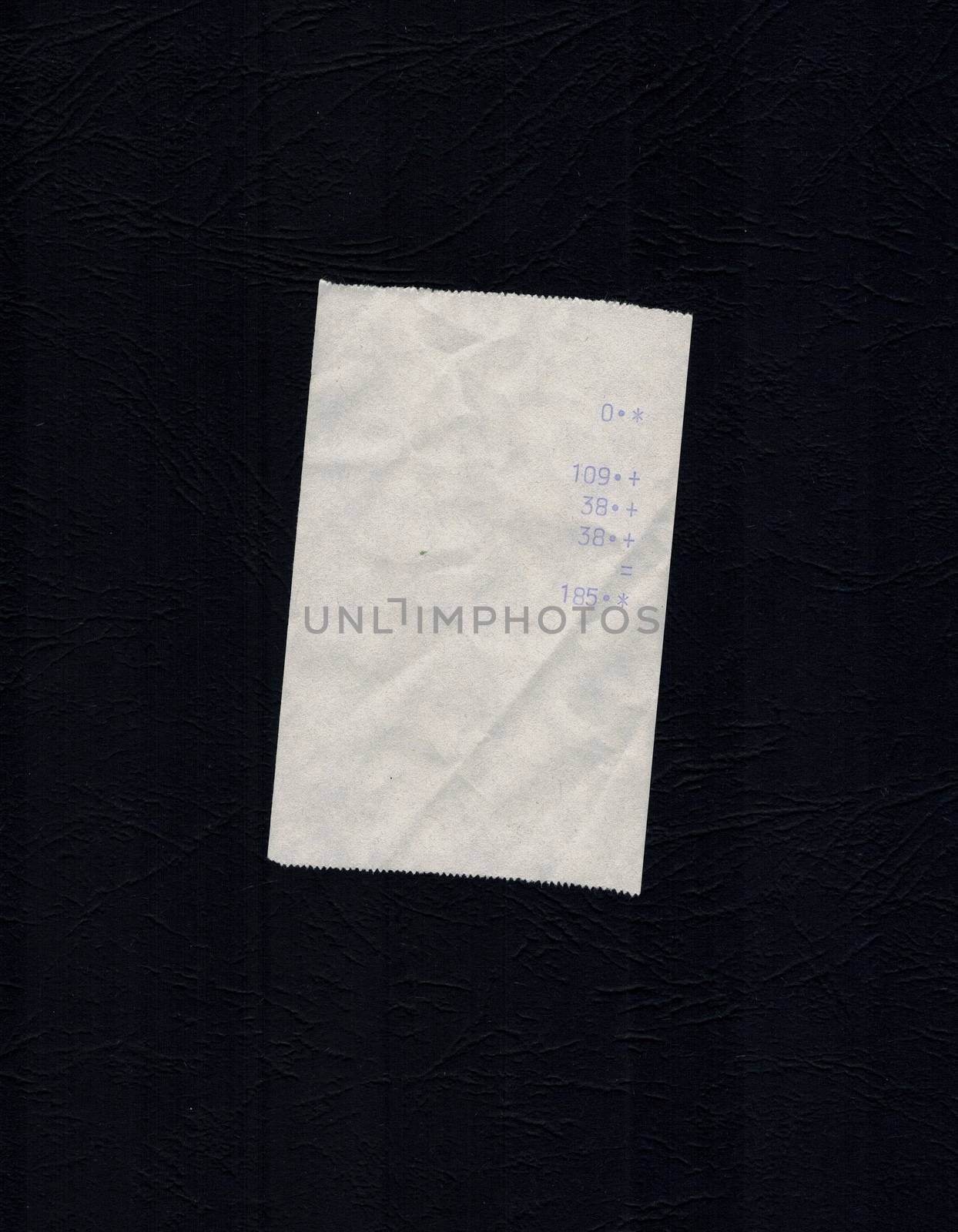 bill or receipt isolated over black background