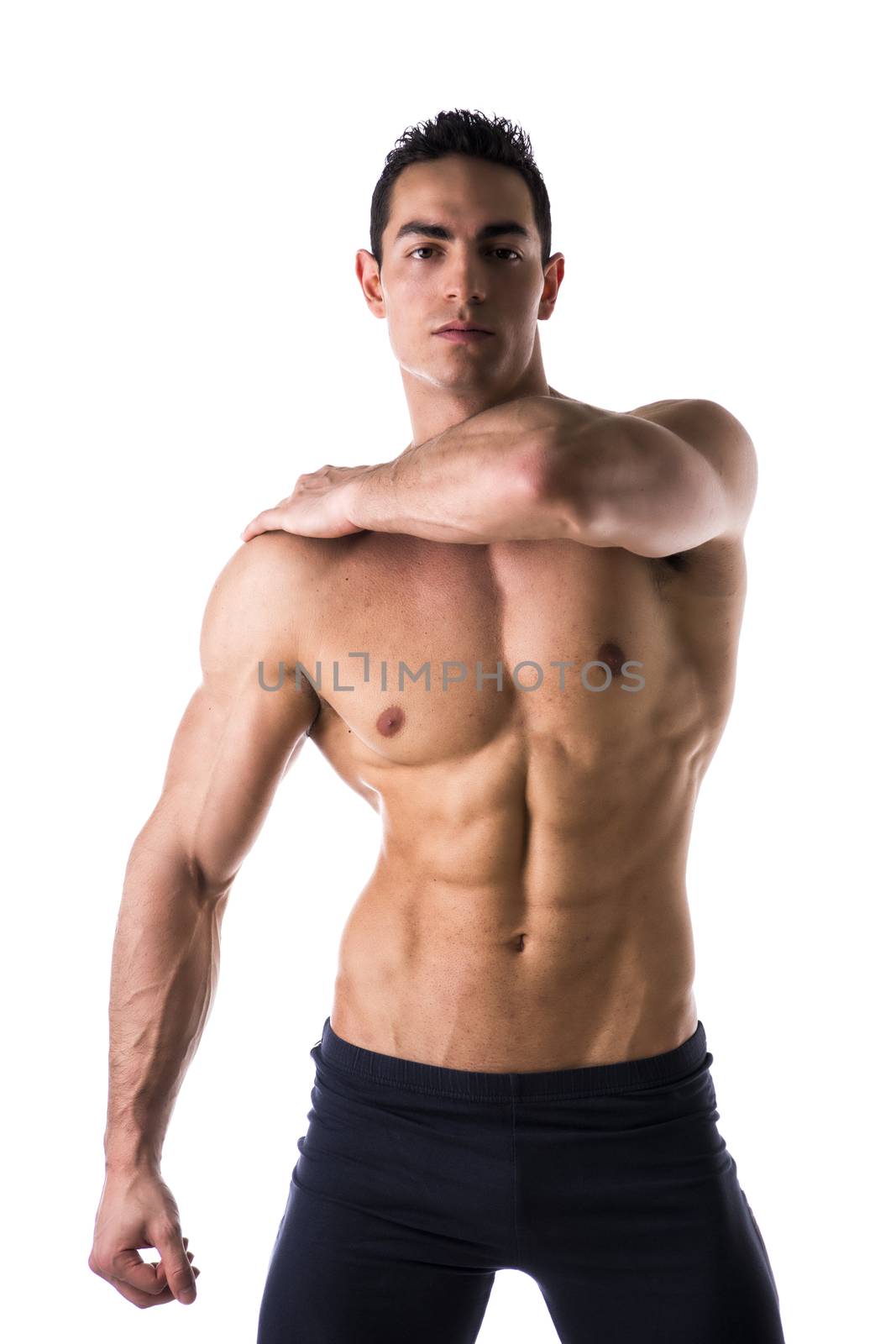 Handsome muscular shirtless young man looking at camera, isolated on white