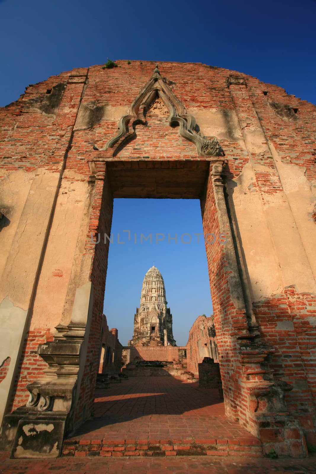 Wat Rajaburana gate and central tower in the background in Ayutt by think4photop