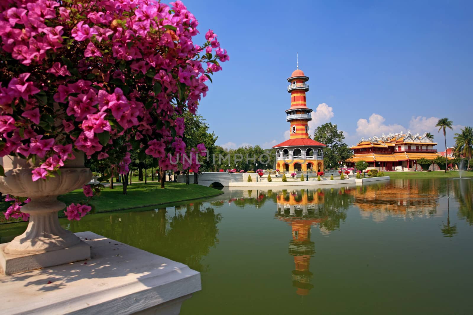 The tall tower in Bang Pa-In Palace, Ayutthaya, Thailand. by think4photop