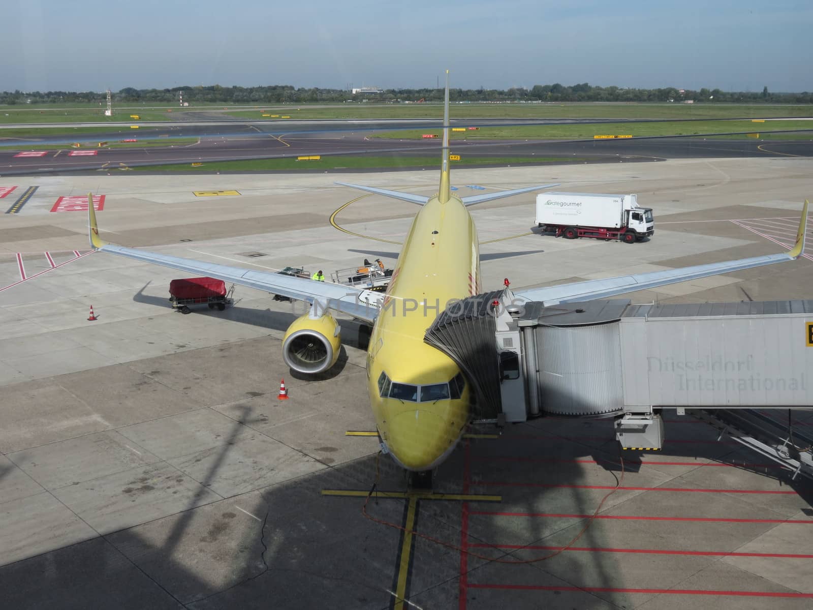 DUESSELDORF (GERMANY), CIRCA OCTOBER 2013: airplane of the DHL mail company parked at the airport ready for boarding, in Duesseldorf, October 2013 