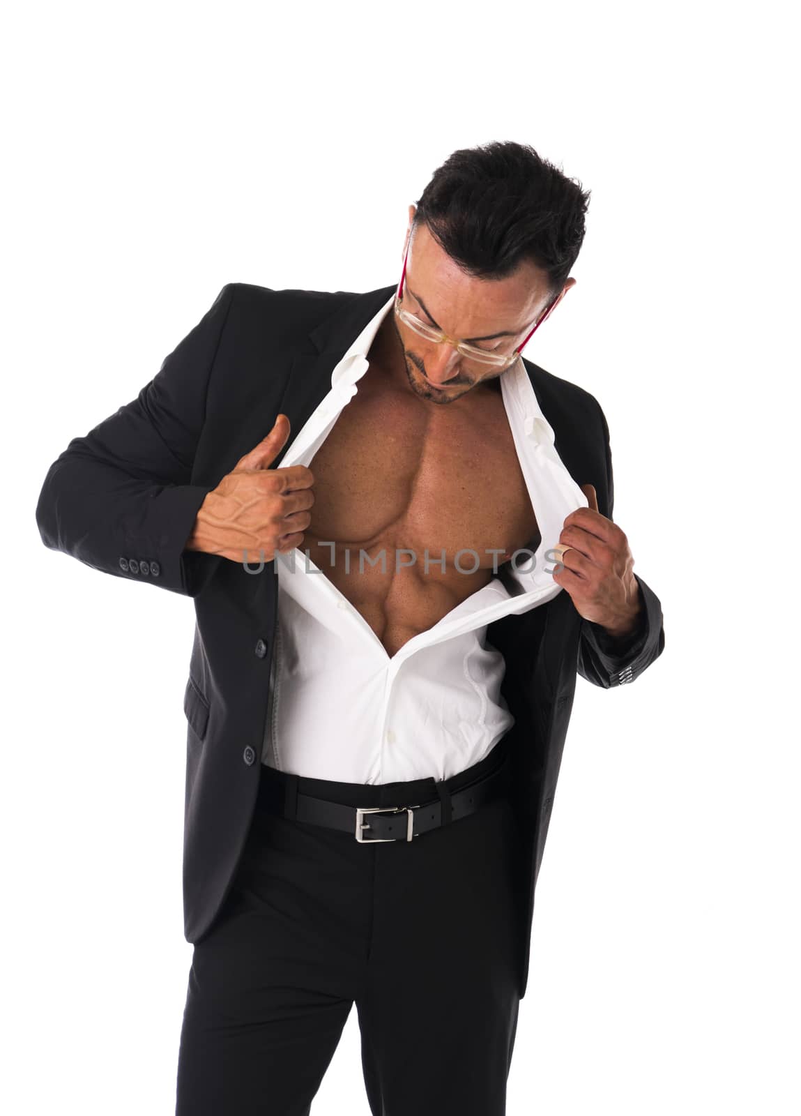 Businessman opening his shirt revealing muscular torso, on white background