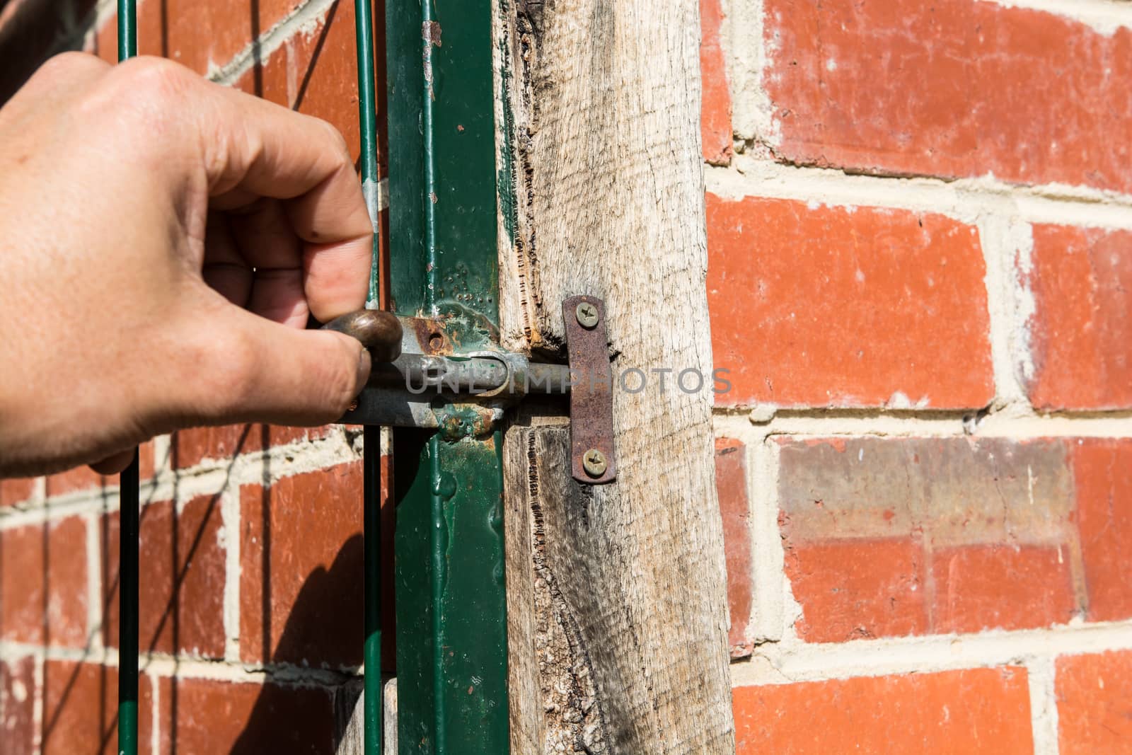 the hand showing the closing the gate of the property