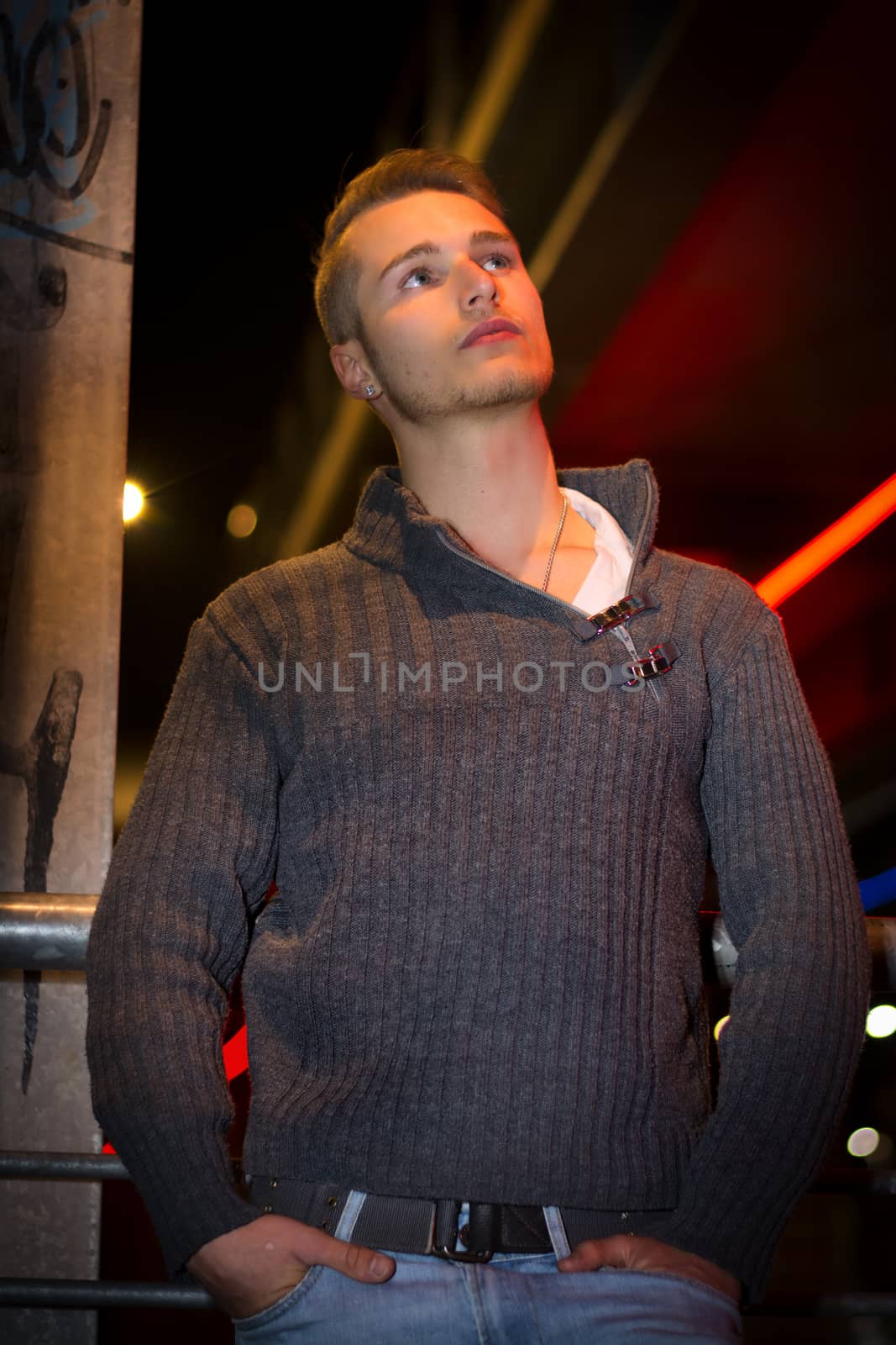 Handsome blond young man alone in urban setting by artofphoto