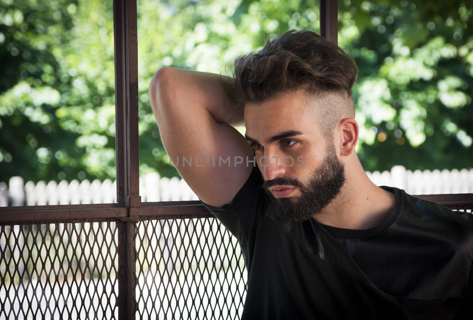 Handsome young man with beard looking to a side