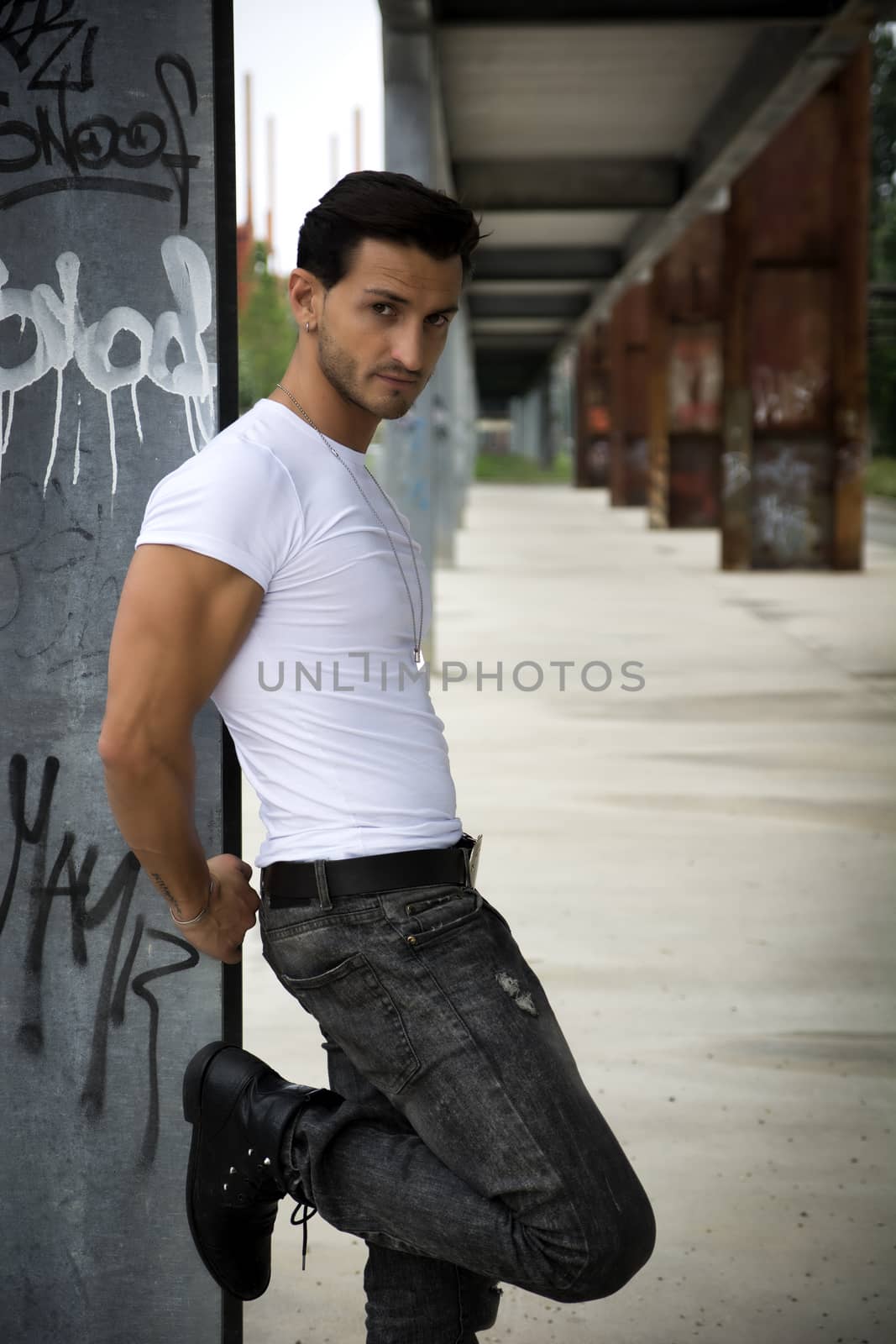 Handsome man outdoor in urban environment looking at camera