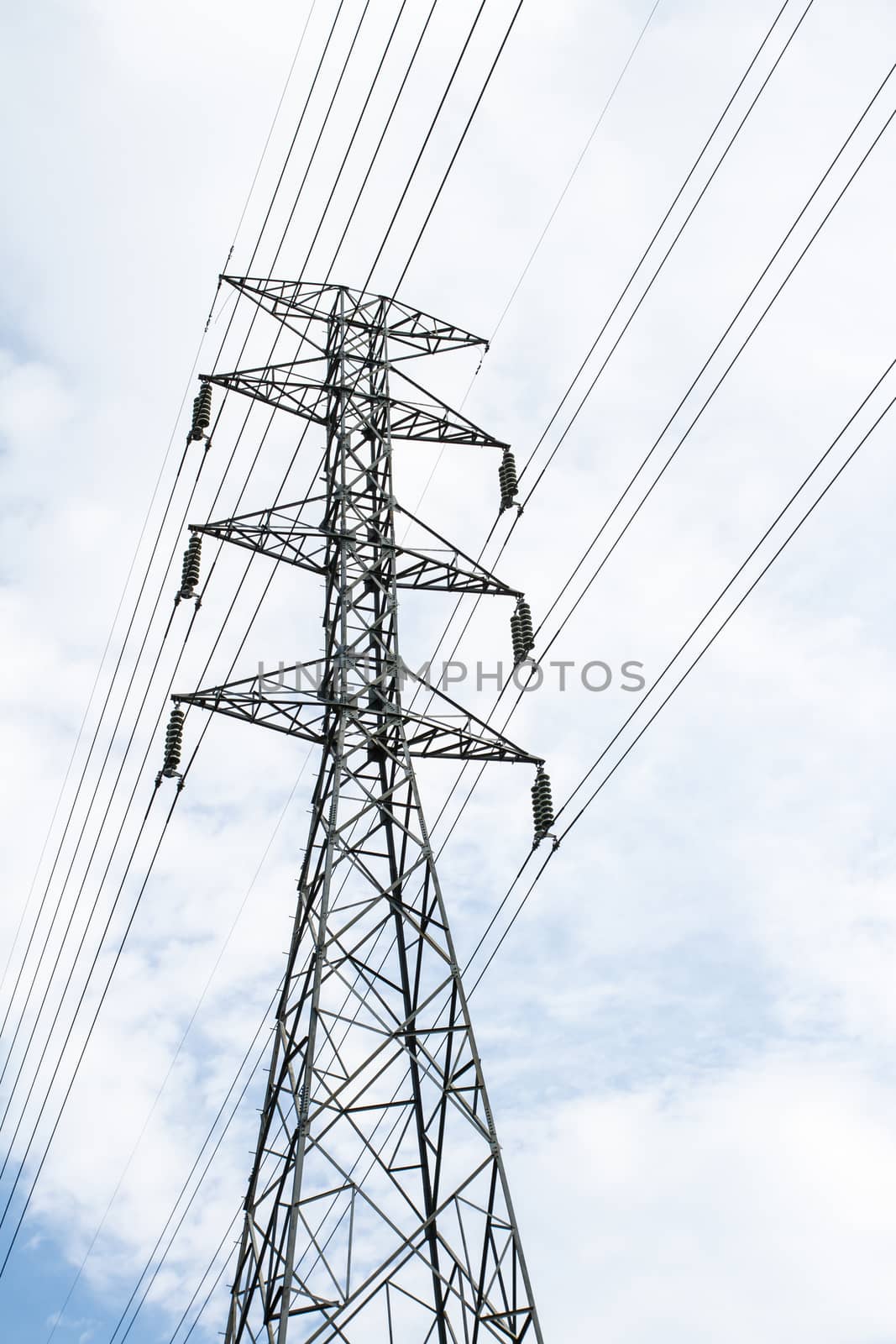 High voltage transmission tower in  sky background