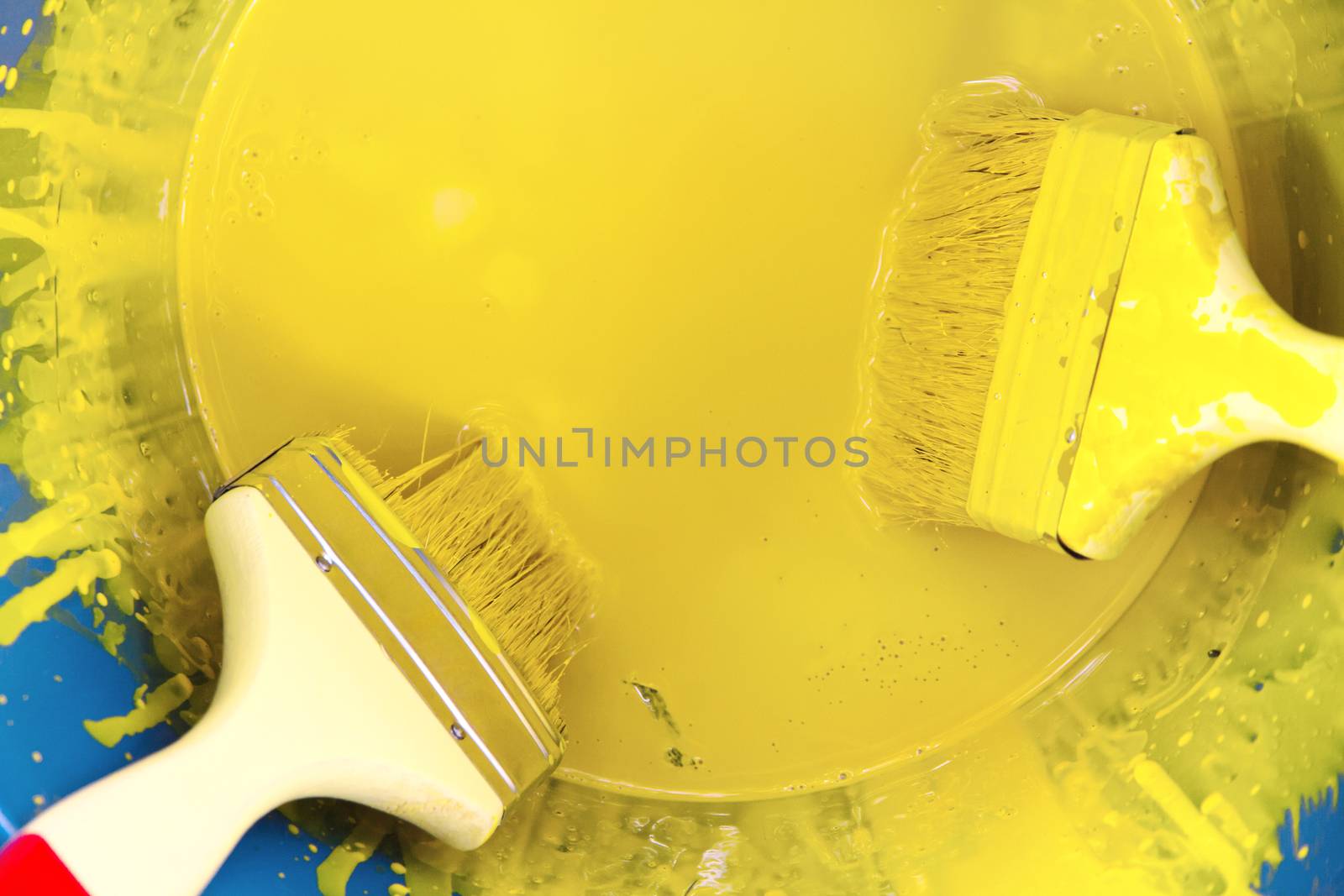 yellow paint can and brush