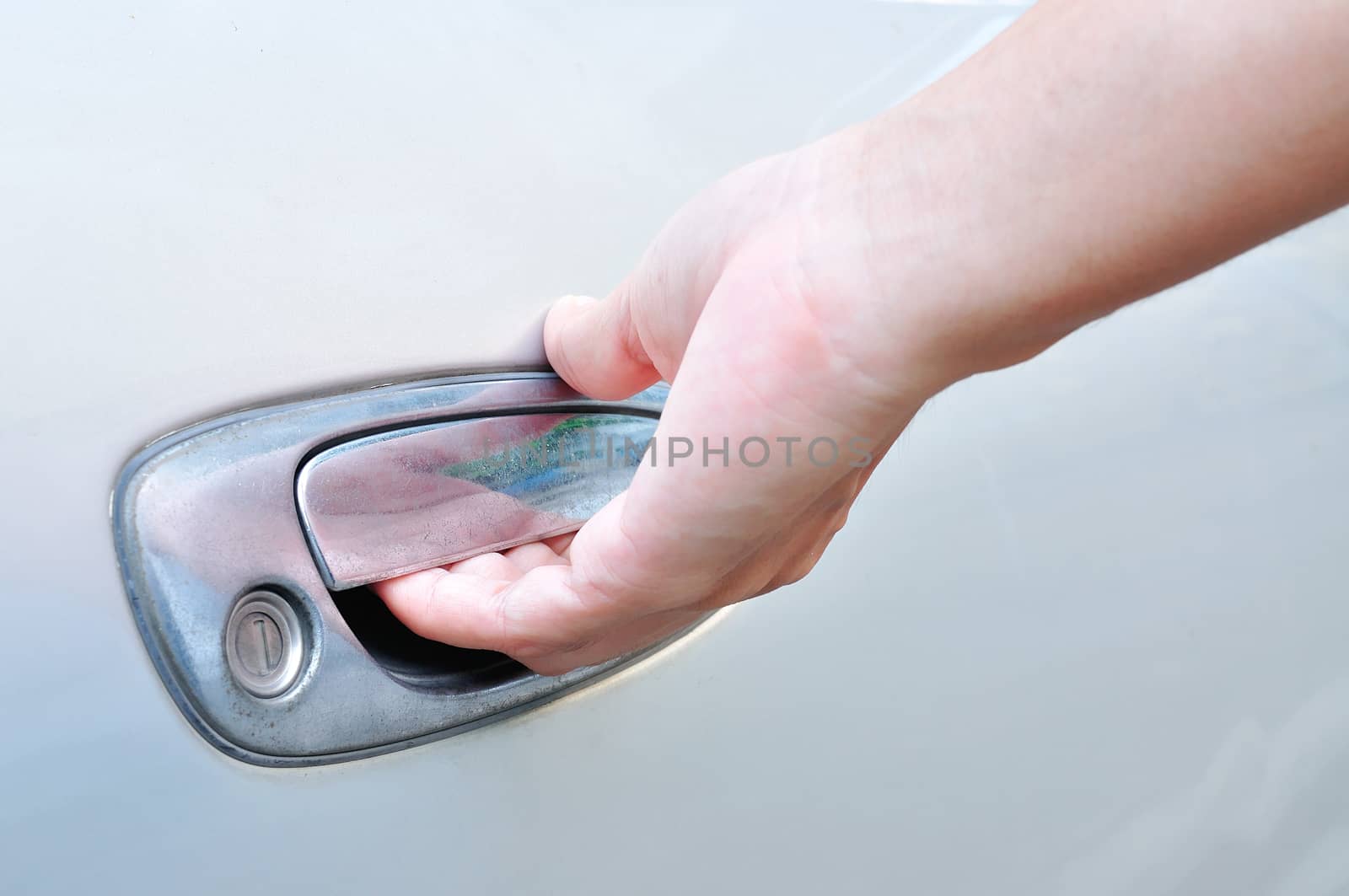 Hand on handle. Close-up of man in formalwear opening a car door for use as Illustration.