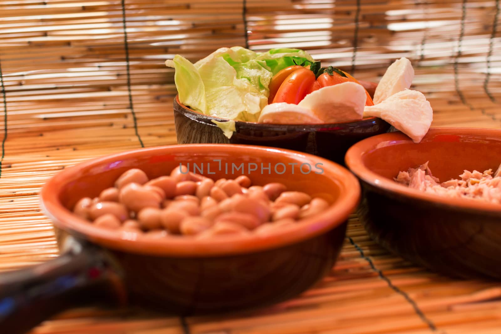 Set of three bowls with salad, beans and tuna