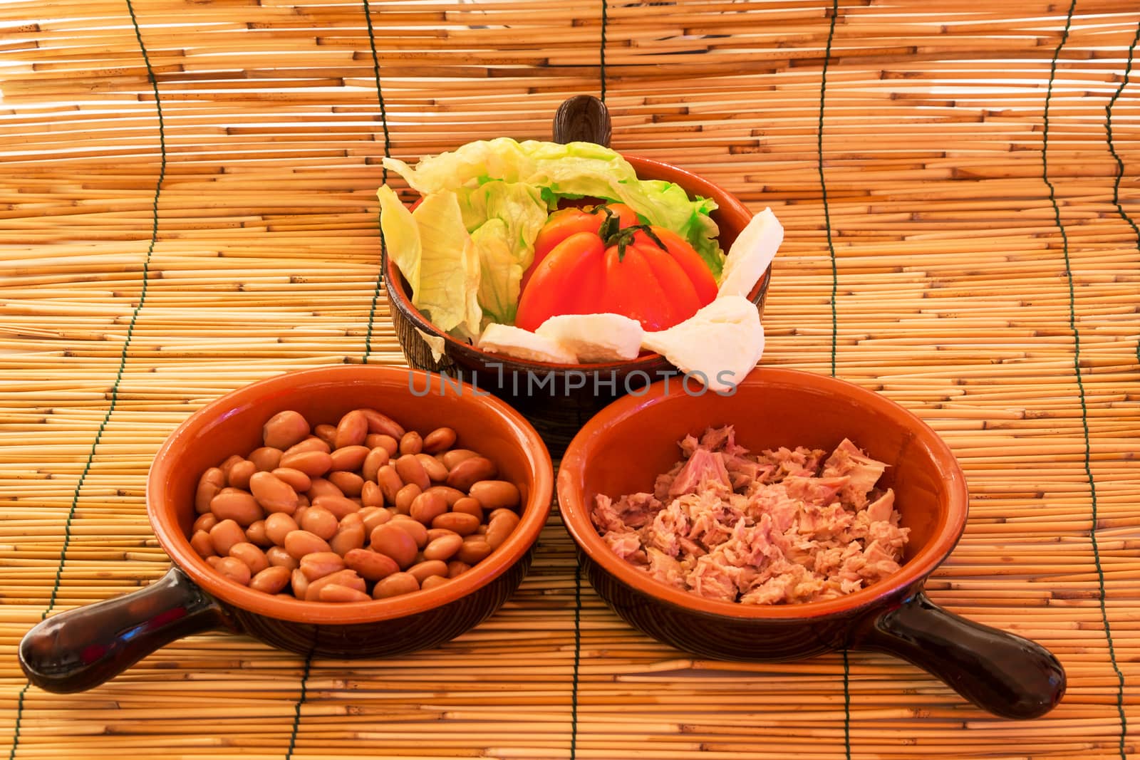Set of three bowls with salad, beans and tuna