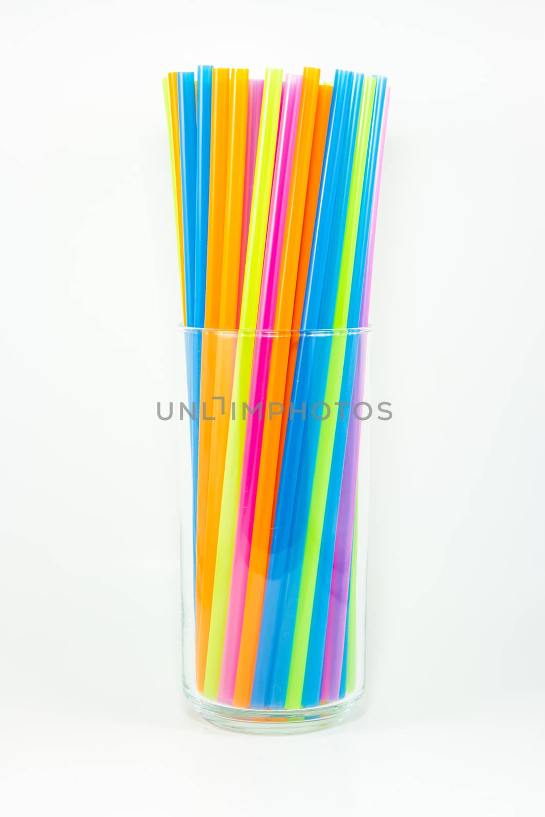 Colorful drinking straws in glass isolated on white background by kasinv