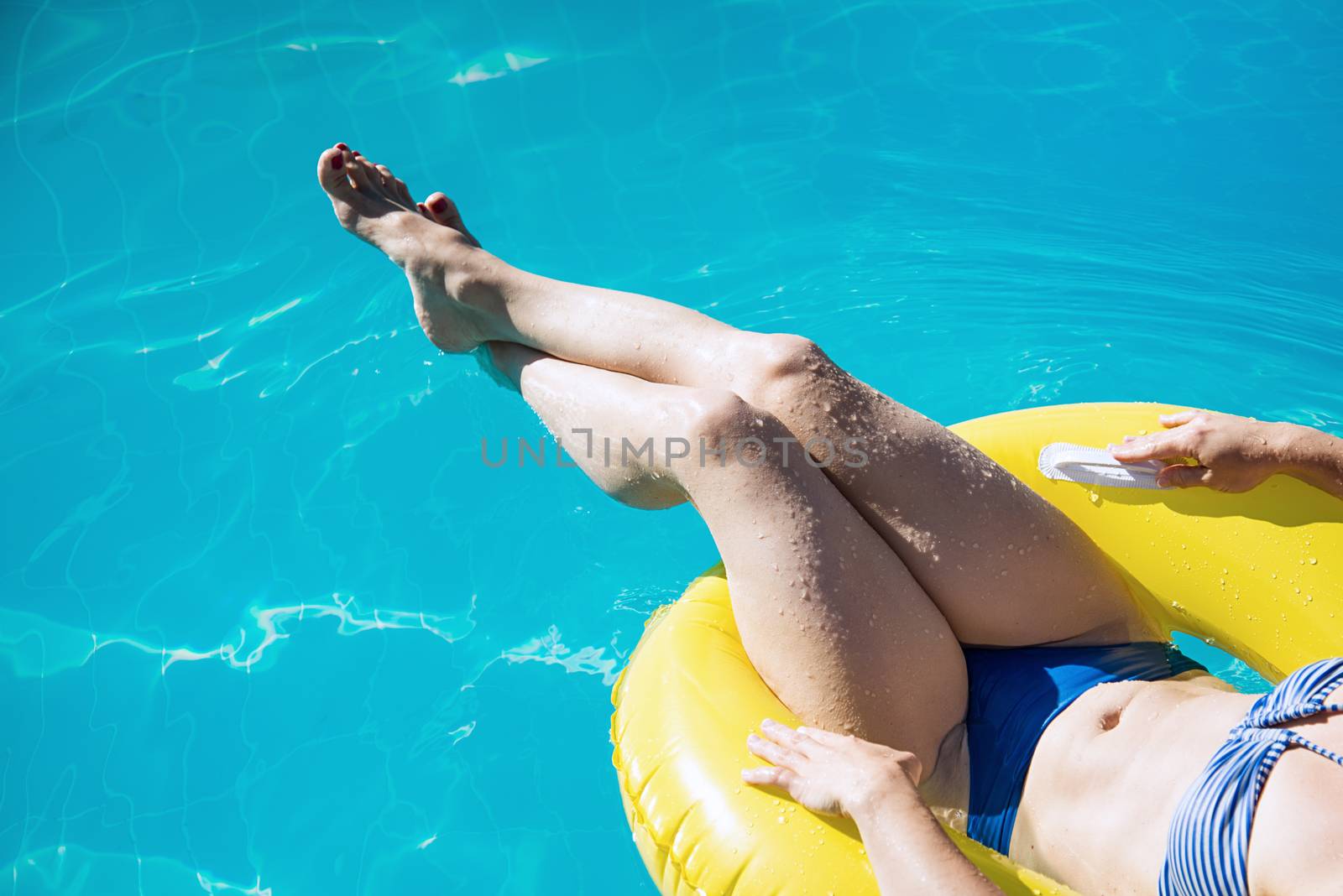 Young woman in bikini enjoying a swimming pool