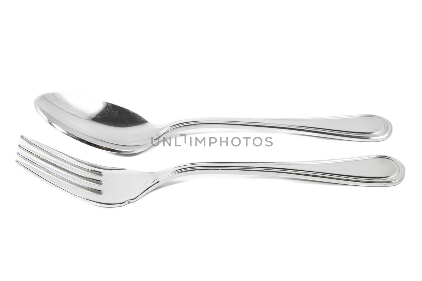 Closeup view of spoon and fork isolated on white background