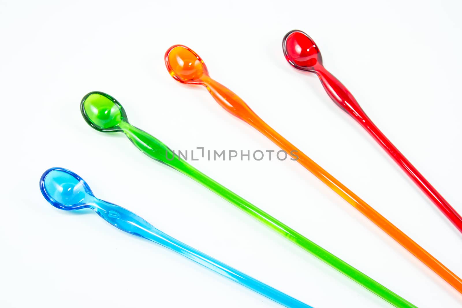 Set of color spoons isolated on white background