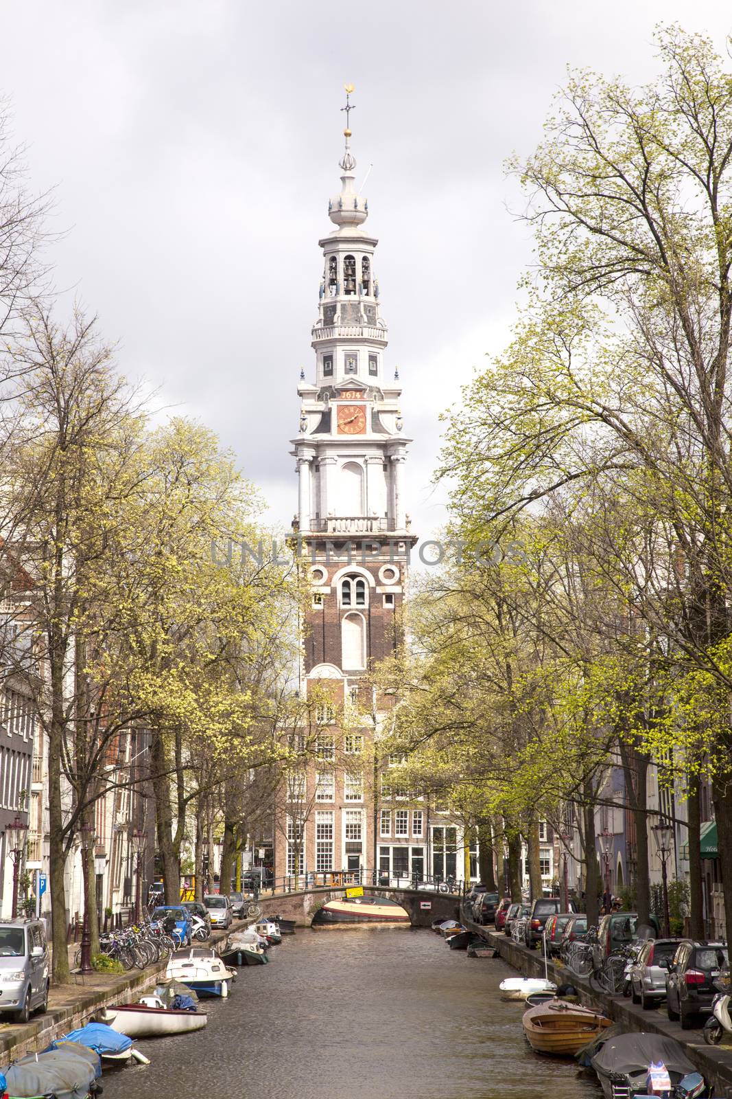 old church tower and canal in Amsterdam by ahavelaar