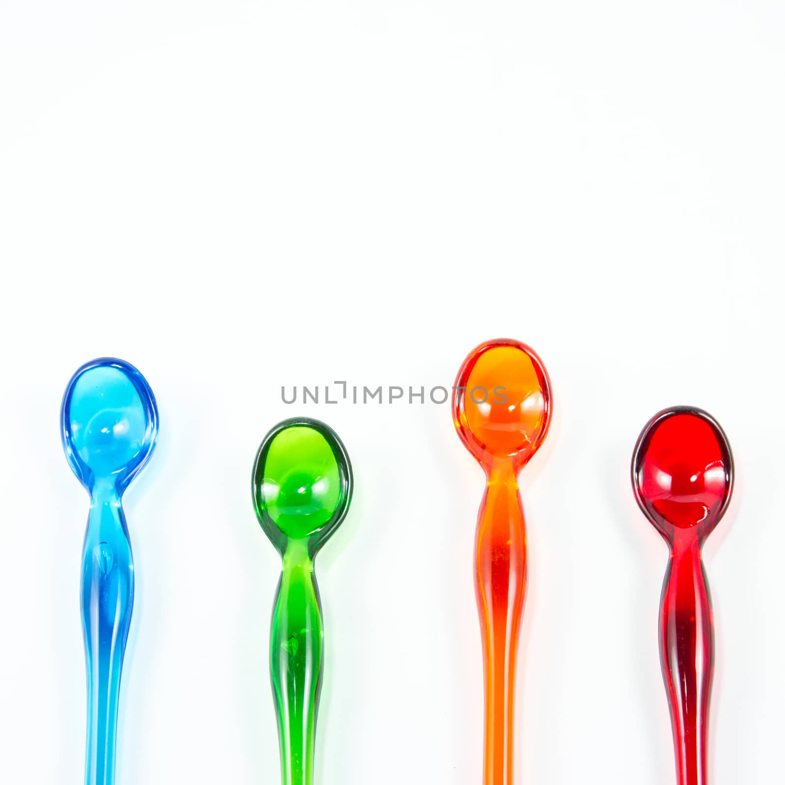 Set of color spoons isolated on white background