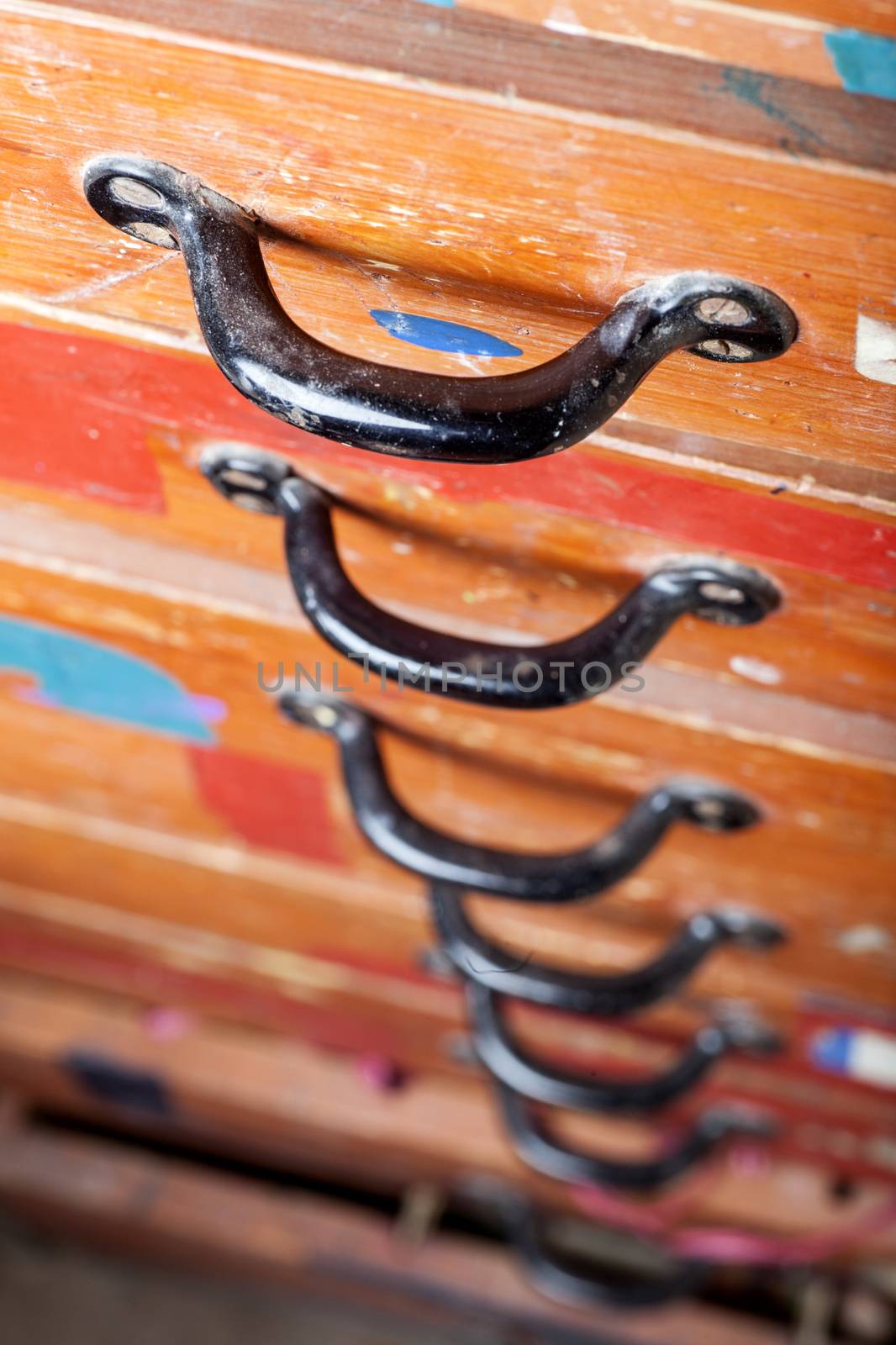 old chest of drawers with black handles in closeup