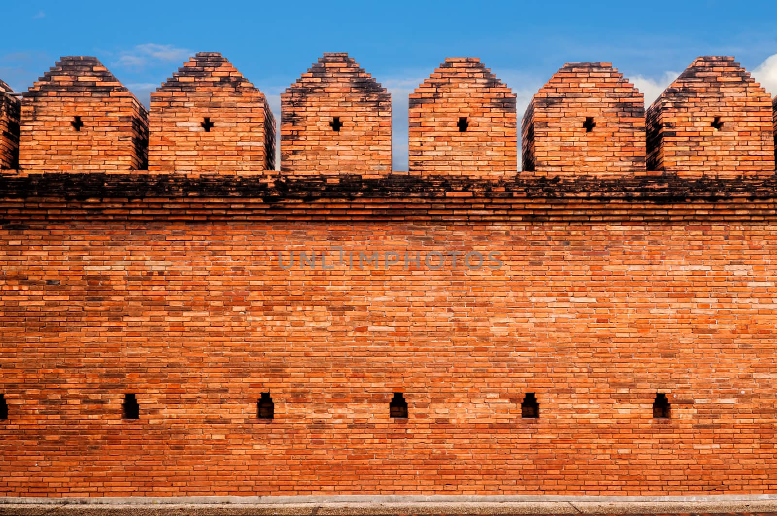 Brick wall of the ancient on blue sky