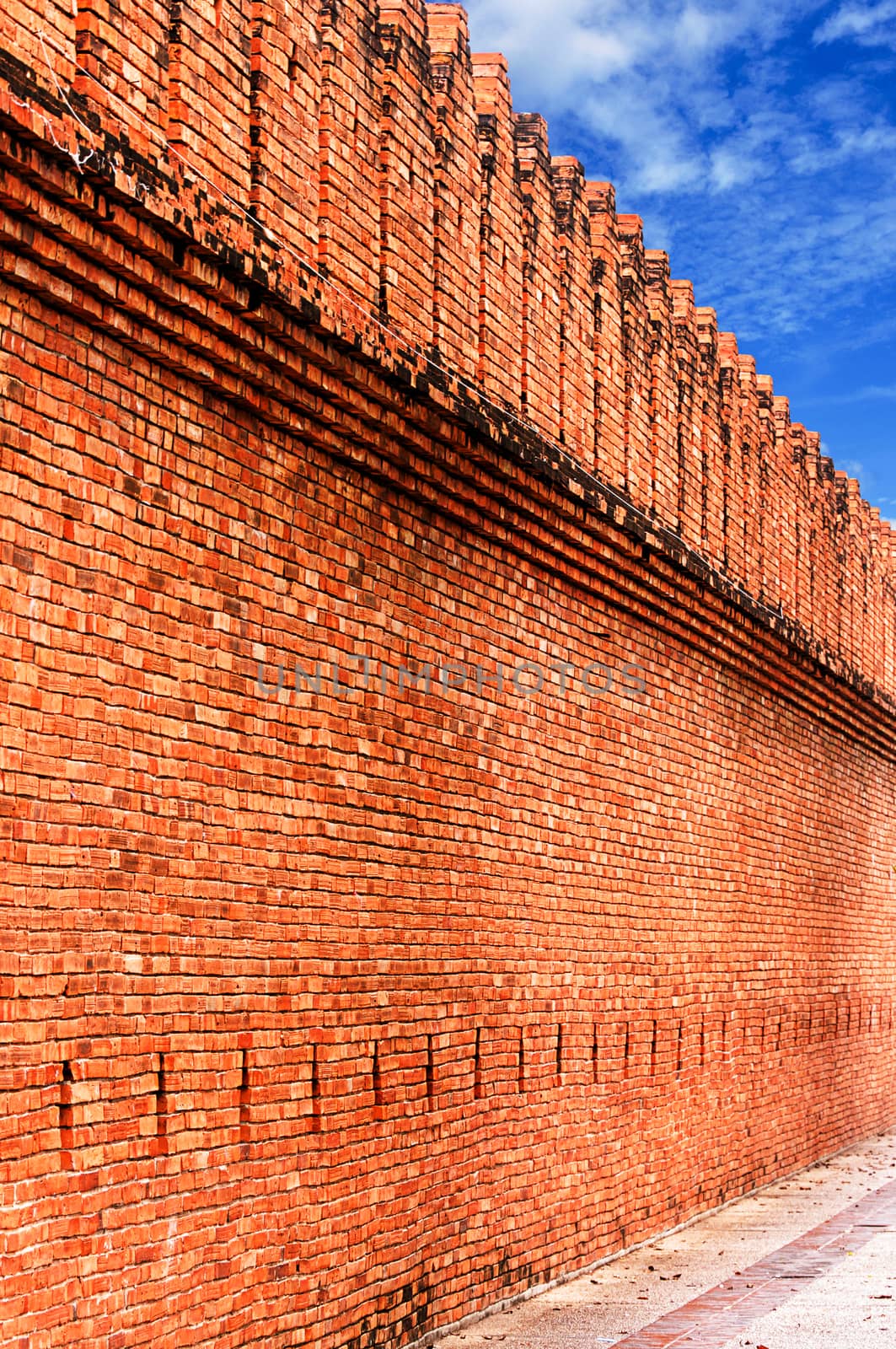 Brick wall of the ancient on blue sky