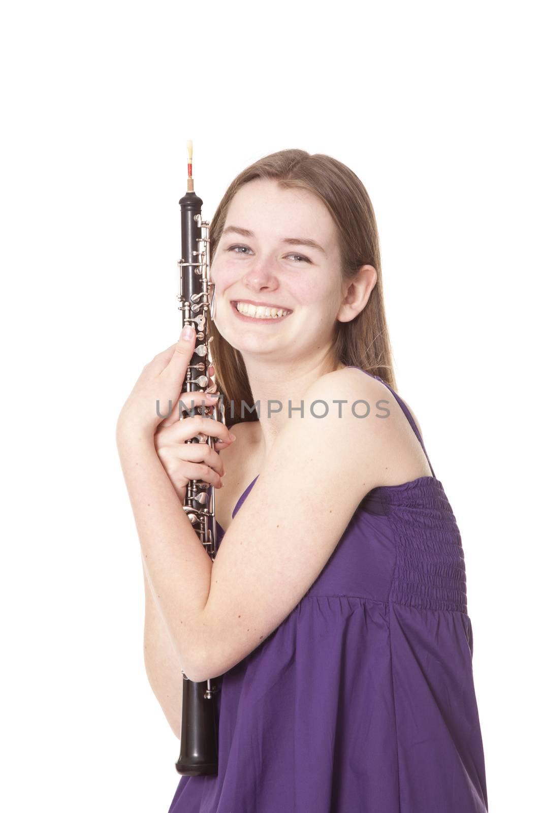 smiling girl in purple dress with oboe against white background