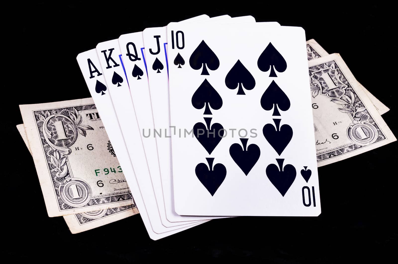 Flush royal cards with money by NuwatPhoto