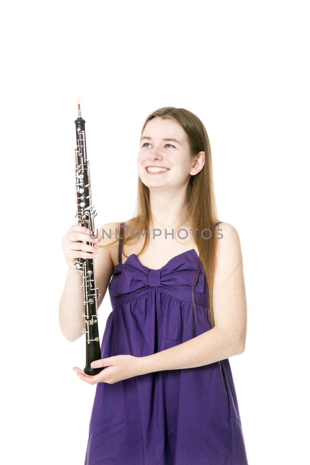 smiling girl in purple dress with oboe against white background