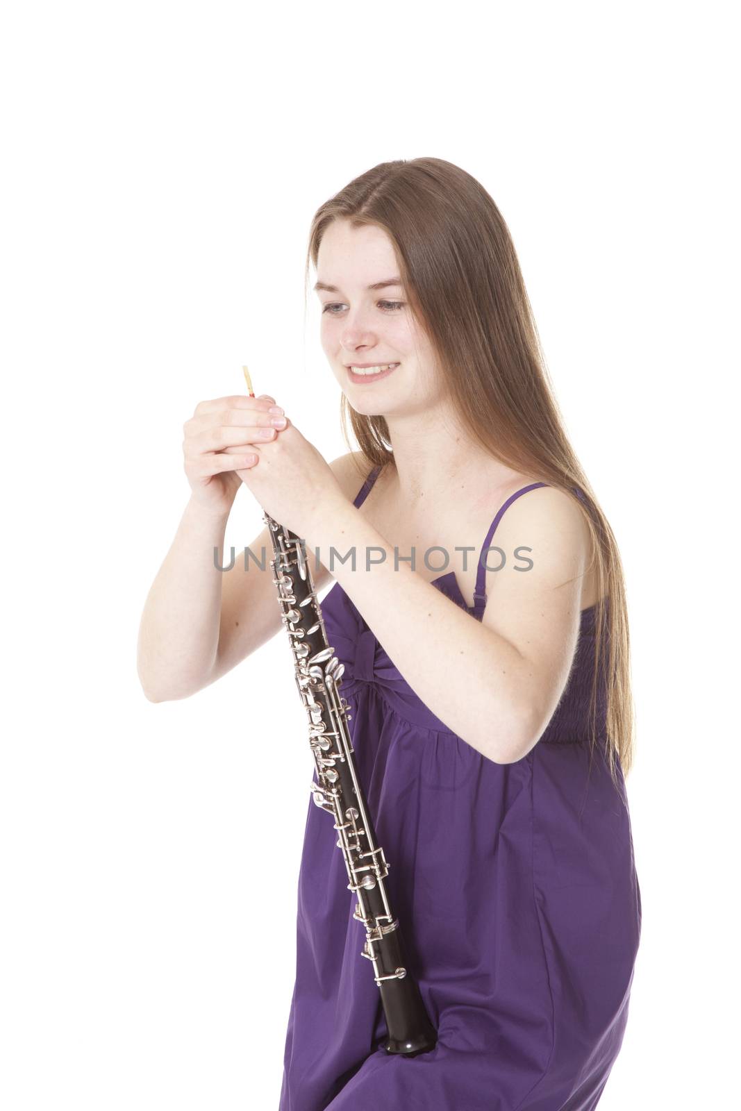 girl in purple dress with oboe against white background