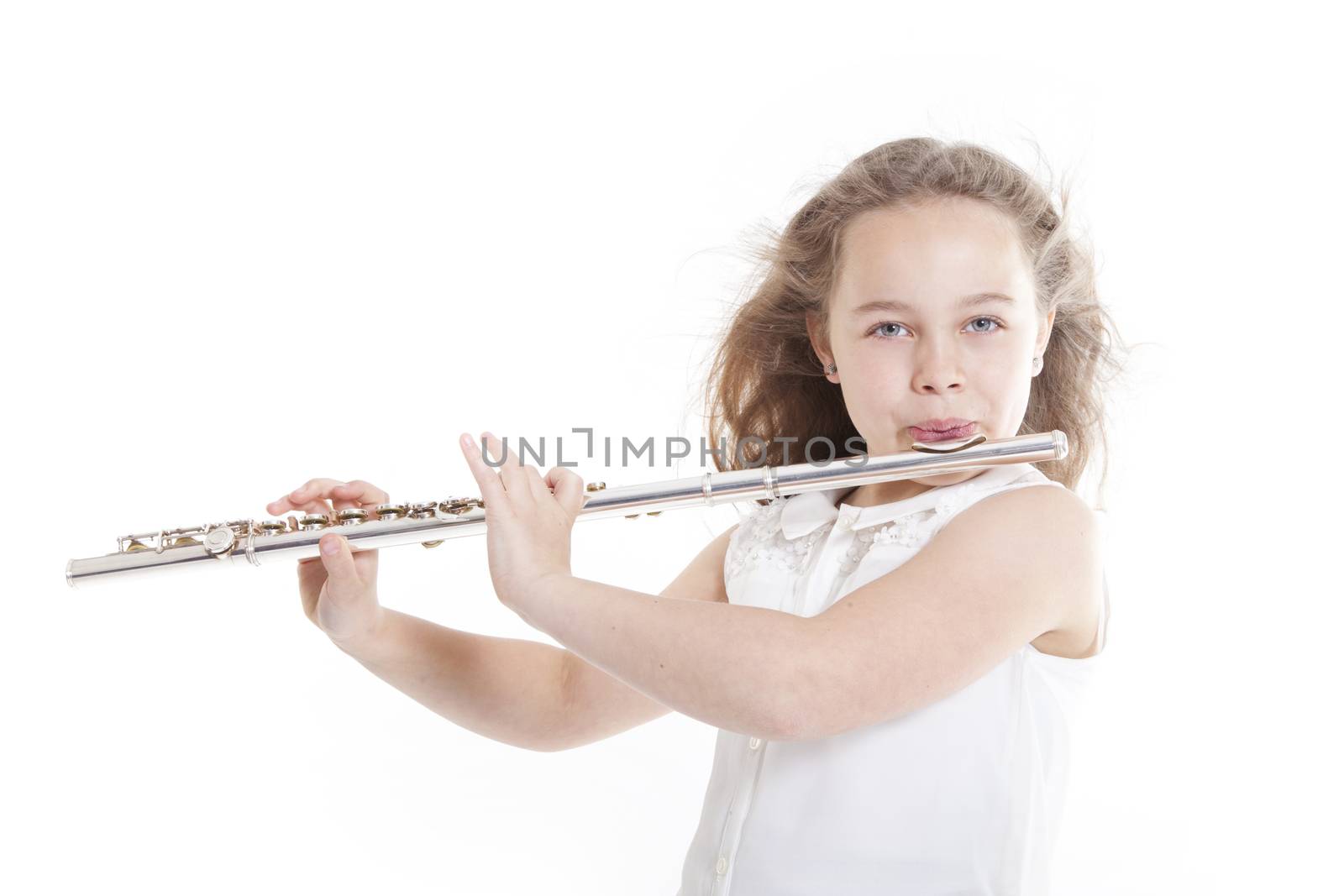 young girl playing the flute against white background in studio