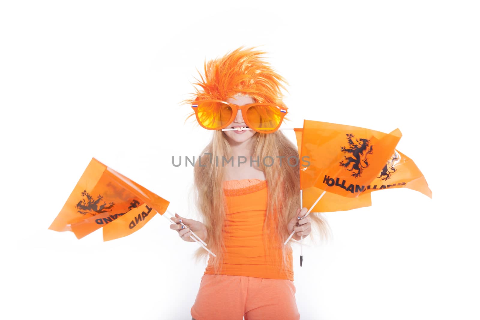 young girl with orange wig and glasses waving flags by ahavelaar