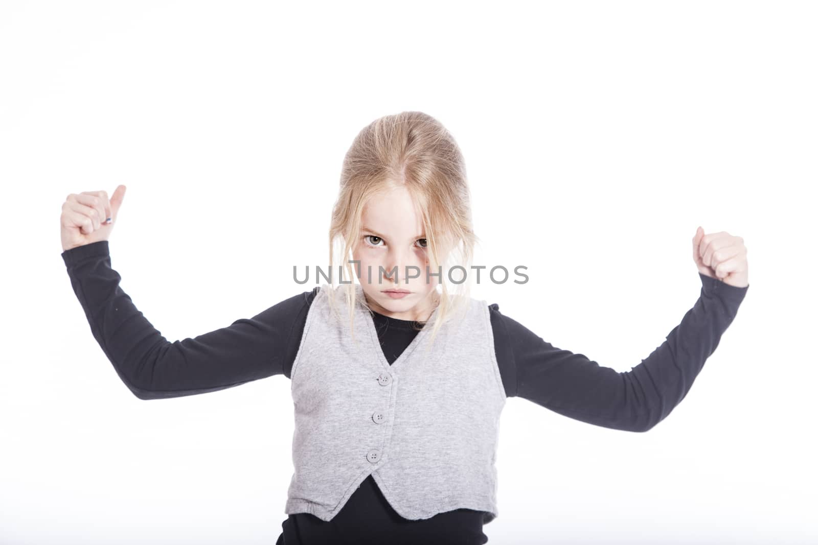 young blond girl showing her strength in studio against white background