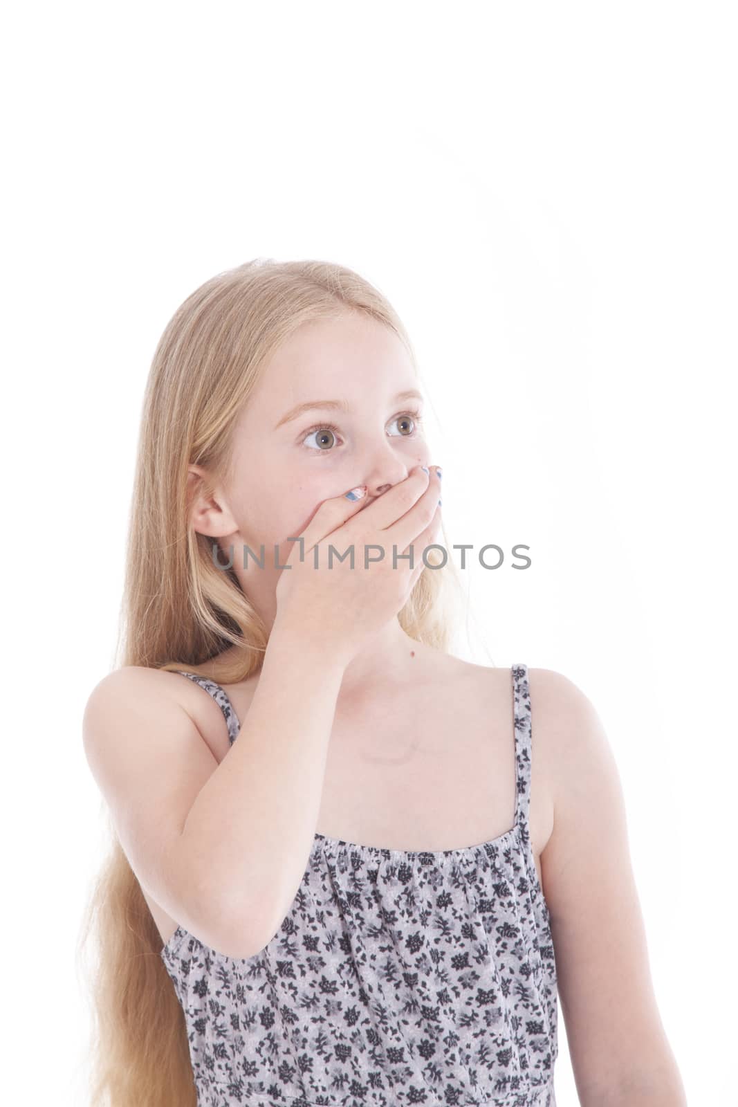young blond girl with astonished expression in studio against white background