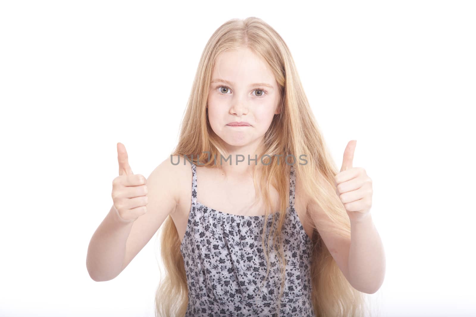 young girl in studio with both thumbs up against white background