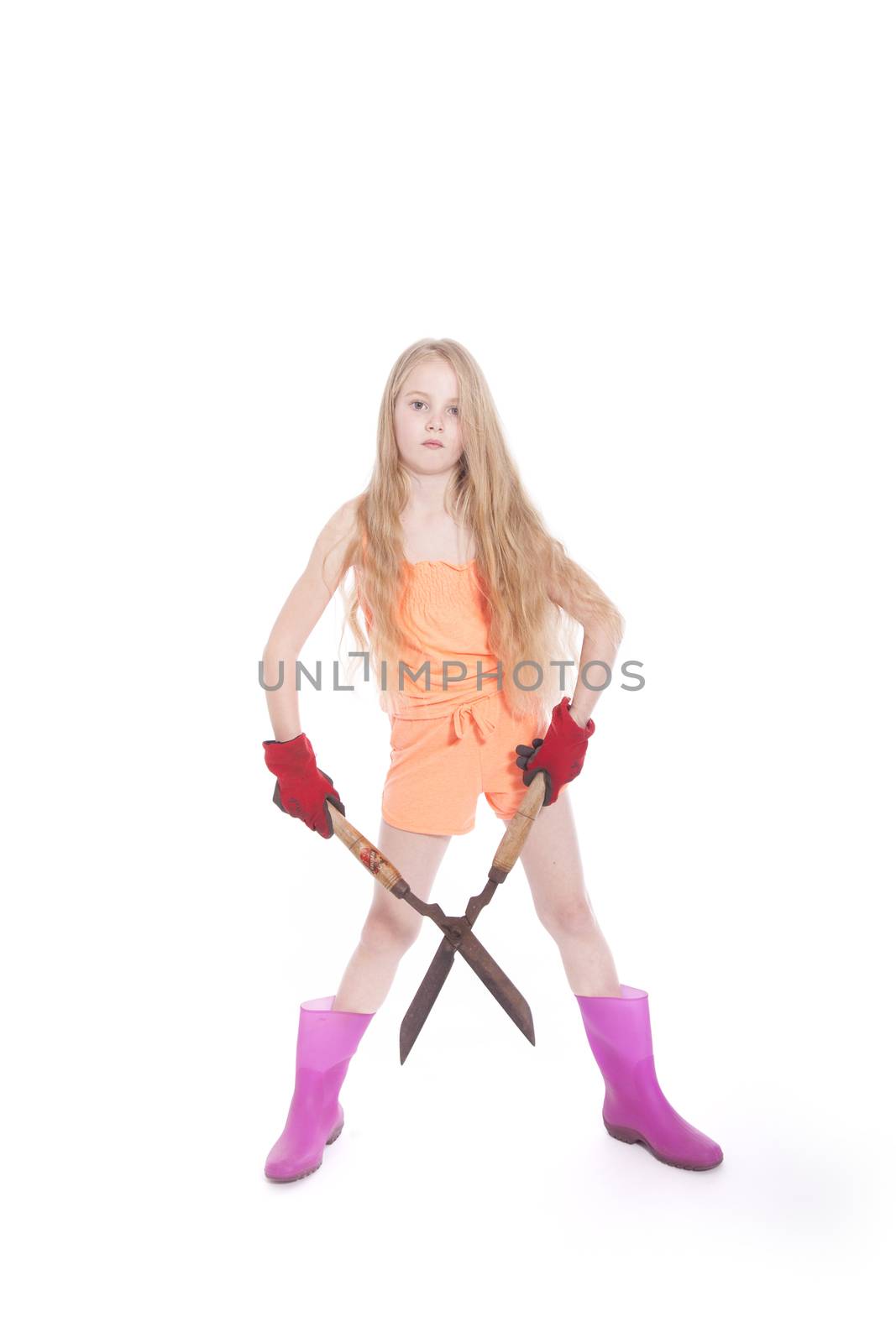 young blond girl with garden shears in studio against white background