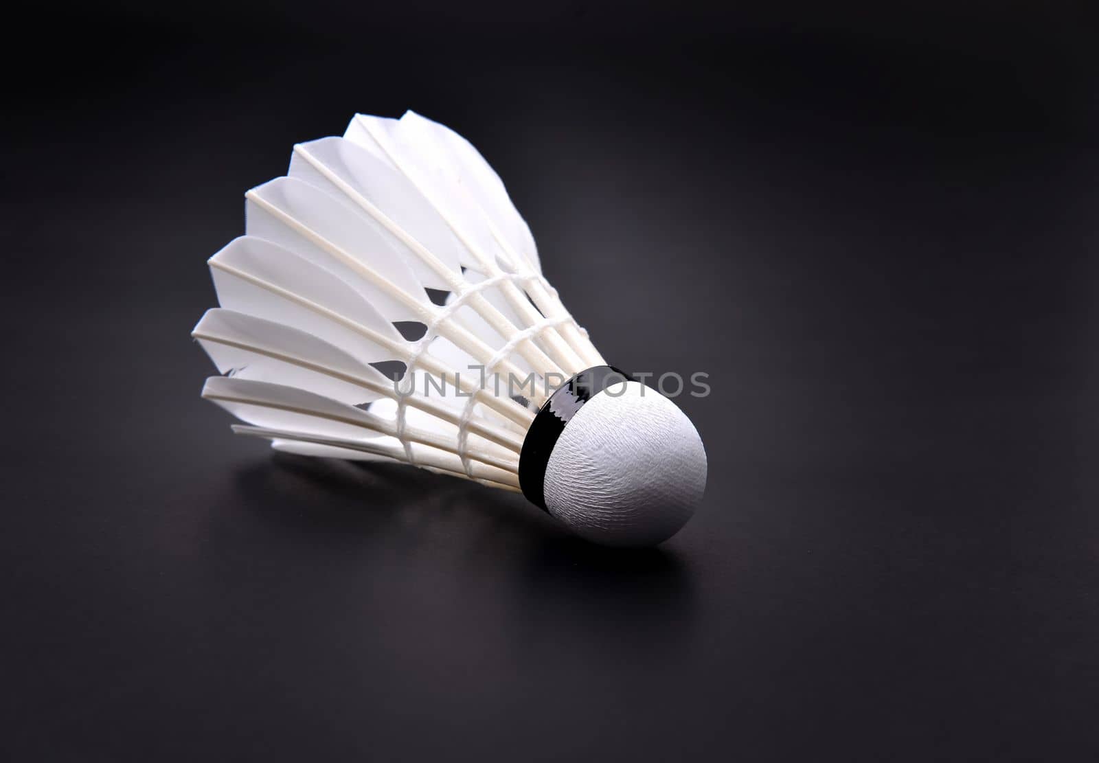 new shuttlecock on dark floor