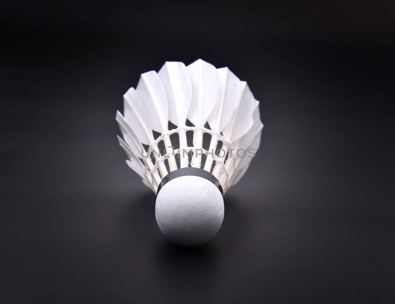 new shuttlecock on dark floor